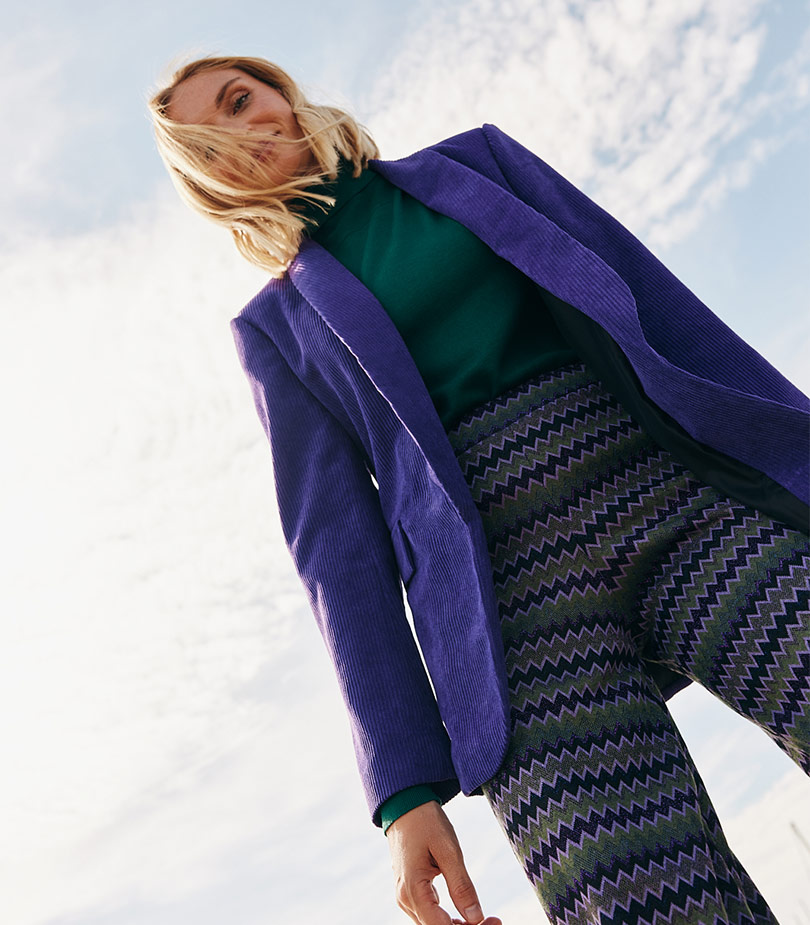 Model with purple vest and printed trousers